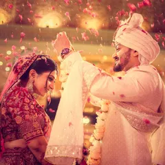The joy of a varmala ceremony is infectious. We capture the energy with dynamic shots, like this one where the couple is showered in petals, freezing a perfect, happy memory in time.