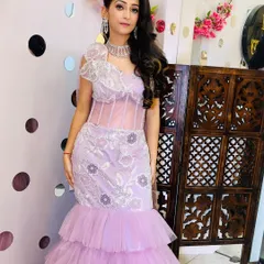 A stunning client in our lavender mermaid-style gown. The sheer corset bodice and tiered tulle skirt create a very glamorous and high-fashion look.