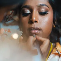 An artistic shot of me working on a bride. I love capturing these quiet, focused moments during the getting-ready process.