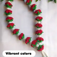 The vibrant red of the roses contrasts beautifully with the white crochet beads. This garland is designed to look full and luxurious, perfect for a wedding ceremony or as a special offering.