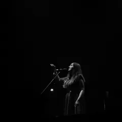 A dramatic black and white shot from my 'Vari' album release concert in Bengaluru. The single spotlight captures the solitude and focus that music requires, even when you're performing for a full house.
