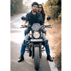 For the adventurous couple, a pre-wedding shoot can be about showcasing your personality. This shot with a Royal Enfield adds a cool, modern edge to the classic couple portrait, captured on an open road.