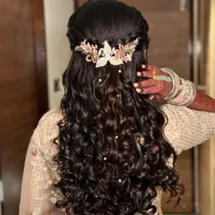 A close-up of the intricate curls and the delicate hair accessory, showing the detail and precision of the styling.