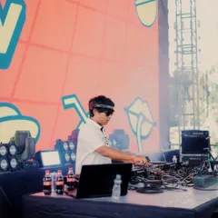 A side profile shot of me focused on the decks during my Zomaland performance. It's all about reading the crowd and dropping the right track at the right time.