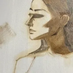 The beginning stages of an oil portrait, known as the underpainting. This monochromatic layer helps establish the light and shadow before any color is added, forming the foundation of the final piece.