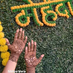 A minimal design for a guest, beautifully photographed against a festive "Mehndi" backdrop.