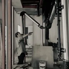 Our integrated design-build team at work. Here, a complex ventilation system is being meticulously installed, showcasing the precision required to execute our designs.