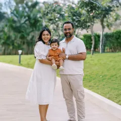 A happy family of three enjoying a walk outdoors. The first year flies by, and photos like these are a perfect way to freeze a moment in time.