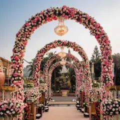 This magnificent entrance features grand arches completely covered in pink and white roses, with crystal chandeliers hanging within each arch. It’s a design that promises a fairytale wedding from the very first moment.