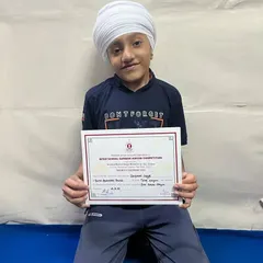 Jaspreet Singh holding his certificate for the Best Tabla Player Award at Shaheed Bishan Singh School, New Delhi.