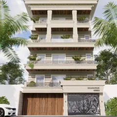 This render presents a timeless residence with intricate stone detailing and a balanced, monolithic structure. The design incorporates classical columns and ornate railings, softened by the inclusion of greenery on the balconies.