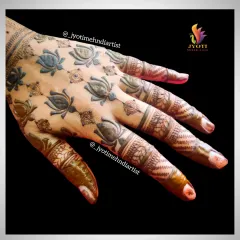 A unique and modern design featuring spaced-out lotus motifs on the back of the hand. This is a great choice for a minimalist bride.