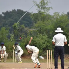 A fast bowler mid-stride, delivering a ball with full effort during our Hyderabad tour match.