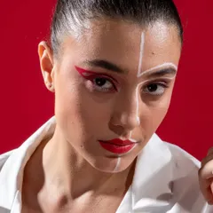 A close-up beauty shot from the Cerise Clothing campaign, focusing on the bold, graphic makeup that complemented the collection's edgy style.