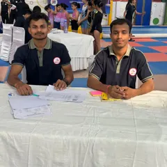Our experienced coaches at the judges' table during a competition. Their expertise is crucial in providing accurate scoring and valuable feedback to our young gymnasts.
