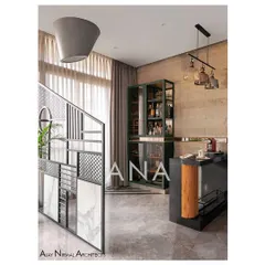 A custom-designed metal partition separates the bar from the sitting area in Apartment 704. The bar itself features rough stone cladding and a modern cabinet, with an inverted conical hanging light elevating the composition.