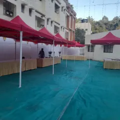 Our team setting up outdoor stalls using gazebos for a corporate exhibition. This is a practical solution for trade shows or fairs, providing shelter and a designated space for each participant.