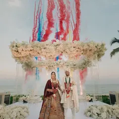 Rahul and Pallavi's spectacular beachside wedding in Hua Hin, Thailand. The ocean backdrop, floral arch, and celebratory smoke create a truly epic and unforgettable destination wedding moment.