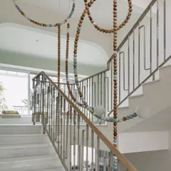 Our LUNA installation is a collaboration with Mother Gone Mad, designed to be a visual centerpiece. The meandering wooden beads represent the phases of the moon, transforming a simple stairwell into a gallery of light and motion.
