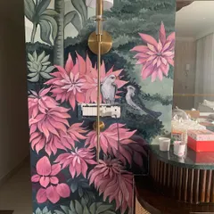 Here is a finished hand-painted nature mural that turns a living space into a tropical escape. We carefully paint around existing features like light fixtures and switches to make the art feel like a natural part of your home.