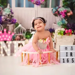 A wider view of the princess-themed first birthday setup. I use props like the light-up crown, birdcages, and floral arrangements to create a magical and enchanting scene.