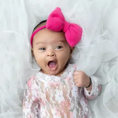 A big yawn from this little girl in her lace outfit. These spontaneous, natural moments are full of personality.