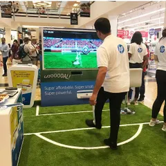 Here is our motion-sensing soccer game in action at an HP brand activation. Participants kick a real ball towards a large screen, where sensors track its speed and trajectory for a fun and competitive penalty shootout experience that draws a crowd.