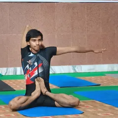 A glimpse from a yoga competition. This young yogi demonstrates a seated twisting pose, showcasing the poise and technique we practice.