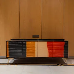 A straight-on view of the ombré stained console. The gradient of colors from black to red creates a stunning visual effect, making it a true statement piece.