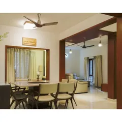 The dining area is seamlessly connected to the living room, defined by a wooden archway that maintains an open feel. The design uses a consistent material palette of wood and neutral tones to create a cohesive flow between the different functional zones of the home.