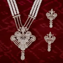This diamond and pearl necklace set is one of my signature bridal designs. The intricate floral-inspired pendant is crafted to sit perfectly, creating a look of pure elegance and grandeur for your special day.