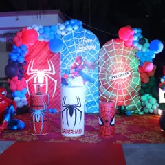 A wider view of the Spiderman birthday setup, showing the full balloon arch in classic red and blue. The personalized name on the backdrop makes the birthday boy feel like the star of the show.