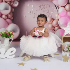 A true star in the making! Adding fun accessories like these heart-shaped sunglasses brings out the playful side of a one-year-old during her milestone photoshoot.