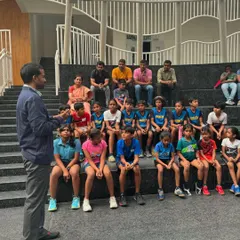 Mr. Gopichand interacting with a group of young, aspiring players, sharing his wisdom and experience in an informal session.