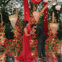 An intimate moment from a romantic engagement party in Goa, set against a backdrop of rich red roses and elegant chandeliers. I believe in creating spaces that not only look beautiful but also feel deeply personal and full of love.
