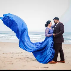 Styling a couple for a beach photoshoot. This royal blue trail gown with lace sleeves flows beautifully in the sea breeze, creating a romantic and powerful image against the waves.