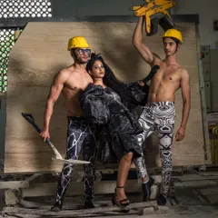 This image from the marble factory shoot combines raw industrial elements with high fashion. The composition uses the factory equipment to frame the models, creating a dynamic and unconventional fashion photograph.