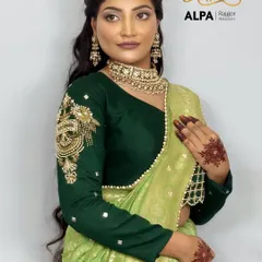 A soft and romantic hairstyle for long hair, paired with a beautiful green saree. The makeup is kept subtle and glowing.