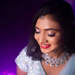 A close-up of Rakshita's reception makeup. The look features a bright red lip and shimmering silver eyeshadow, perfect for an evening celebration.