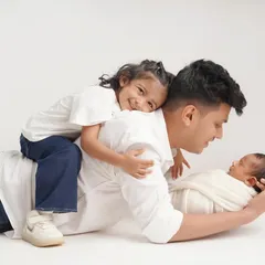 A sweet interaction between father, daughter, and his new baby. These lifestyle shots capture the real relationships and the fun of being a family.