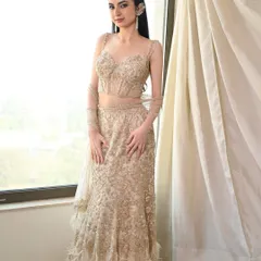 The full look from our editorial shoot. The sleek hair and makeup are the perfect pairing for this stunning, feathered, and embellished gown.