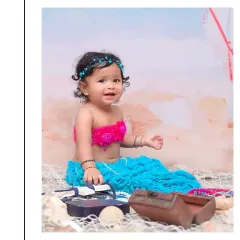 A beautiful baby girl dressed as a little mermaid, complete with a colorful tail and seashell props. My fantasy-themed sessions, like this under the sea adventure, are perfect for creating magical portraits.