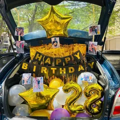 Another view of the photo-filled car boot, showing the large star-shaped foil balloons.