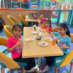 A candid moment of friends enjoying snacks and juice at our cafe.