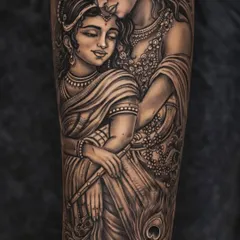 This Radha Krishna tattoo is a story of eternal love, created with immense detail. I've used fine lines and soft shading to capture the divine emotion and connection between them. Look closely at the delicate jewelry, the serene expressions, and the peacock feather, all coming together to create a piece that is truly 'shandaar'.