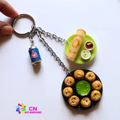 An assorted keychain featuring pani puri and dosa, a perfect gift for a street food lover.