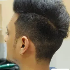 The "after" shot, showing a sharp fade and expertly styled top. A complete style upgrade.