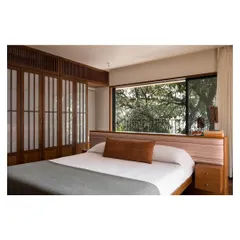For this master bedroom, I designed a low-profile island bed with an integrated headboard and side tables. The goal was to maintain an uncluttered, zen-like space that feels open and connected to the view, making the room a true sanctuary for rest.