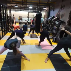 To balance the high-energy workouts, we offer yoga classes focused on flexibility, strength, and mindfulness. Here, our members are in a group yoga session, working on their form and finding their focus together.