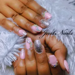 This pink and silver set is all about texture and shine. It combines solid pink nails, full silver glitter accent nails, and nails adorned with a cascade of iridescent rhinestones for a dazzling effect.